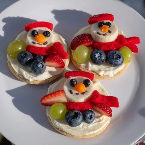 Delicious Melting Snowman Fruit Pizza, a colorful and fun treat with fresh fruit and frosting.