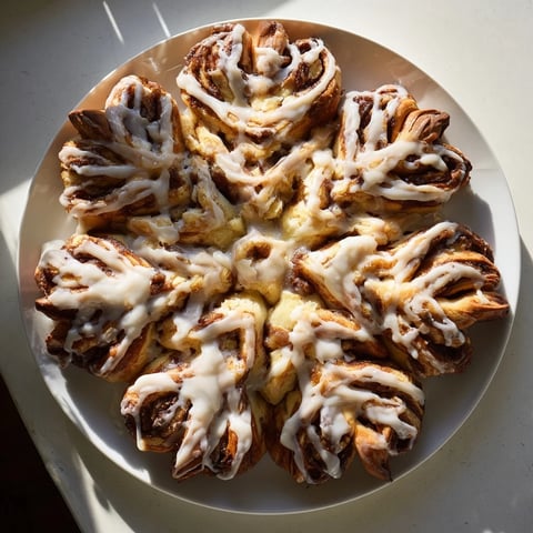 Fluffy Giant Snowflake Sweet Roll, golden-brown and glistening, a beautiful breakfast centerpiece.