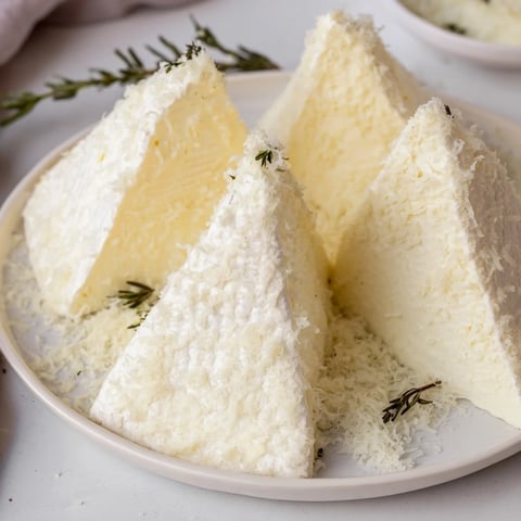 Elegant Snowcapped Range appetizer showcases creamy Brie mountains dusted with Parmesan snow.