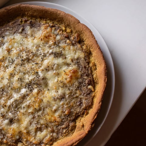 Golden and crisp cauliflower pizza crust, ready for toppings with a savory aroma filling your kitchen.