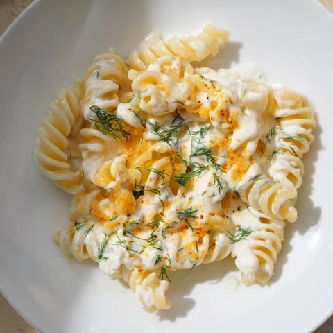 Steaming bowl of Turkish Yogurt Pasta, swirled with creamy yogurt and aromatic spiced butter.