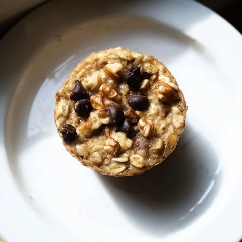 Golden-brown Baked Oatmeal Cups, bursting with berries, perfect for a quick and satisfying breakfast.