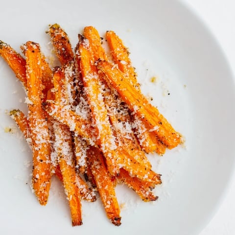 Crispy Parmesan Baby Carrot Chips glistening from the oven, ready to enjoy as a flavorful side dish.