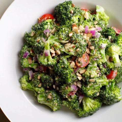 Vibrant Garlic Parmesan Broccoli Salad with cherry tomatoes and creamy dressing, perfect side dish.