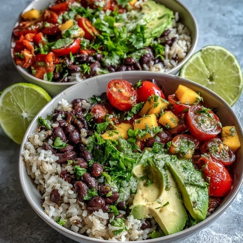 Freshly diced mango and warm black beans mounded on fluffy brown rice in a Mango and Black Bean Brown Rice Fiesta Bowl.