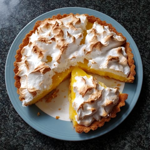 A slice of lemon meringue pie on a plate.