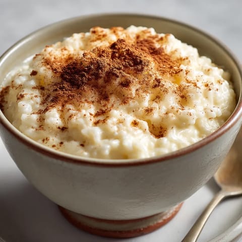 A bowl of rice pudding with cinnamon on top.