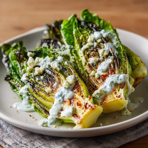 A charred romaine wedge salad with blue cheese foam.