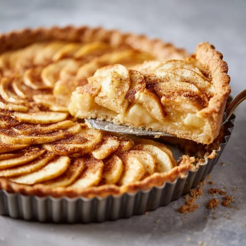 A slice of apple pie with a spoon in it.
