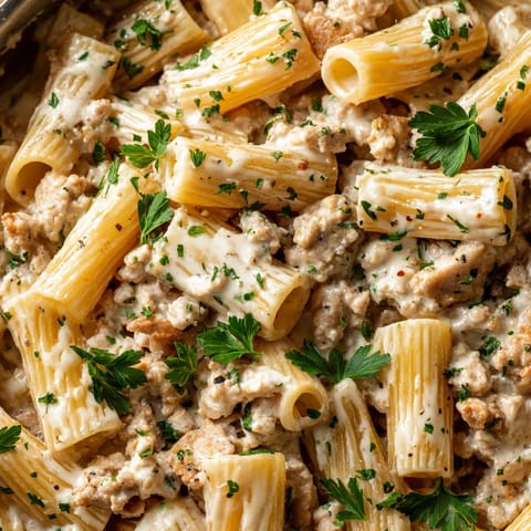 A dish of pasta with ground turkey and cheese.