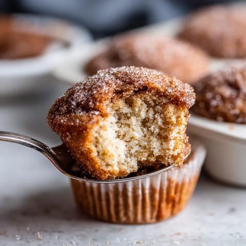 A cupcake with a bite taken out of it.