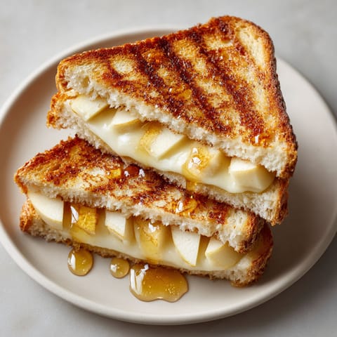 A slice of smoked gouda and apple grilled cheese.