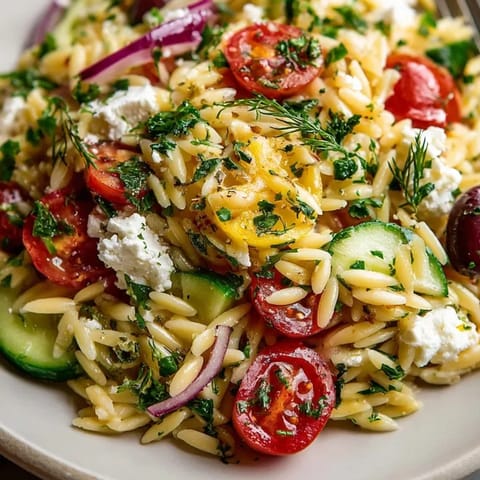 Close-up of Greek Orzo with Feta and Olives, showcasing the vibrant colors and textures.