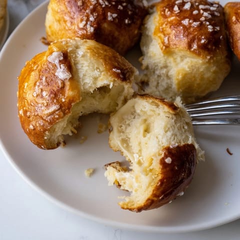 Warm, cheesy Soft Pretzel Biscuit Bombs, a delicious snack or appetizer recipe.
