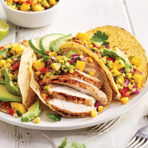Close-up of Mango Corn Salsa Chicken Tacos showcasing juicy chicken and colorful fruit salsa.