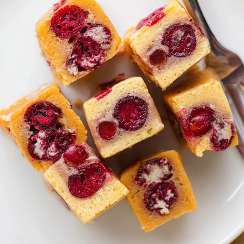 Top-down view of freshly baked Thanksgiving Cranberry Mochi Squares, sprinkled with coconut.