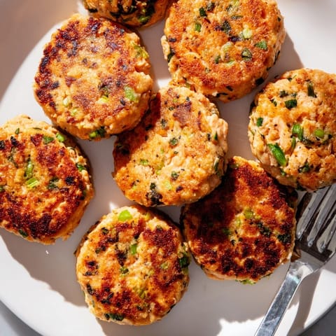 Crispy salmon patties with fresh garlic and ginger, served hot with lemon.  