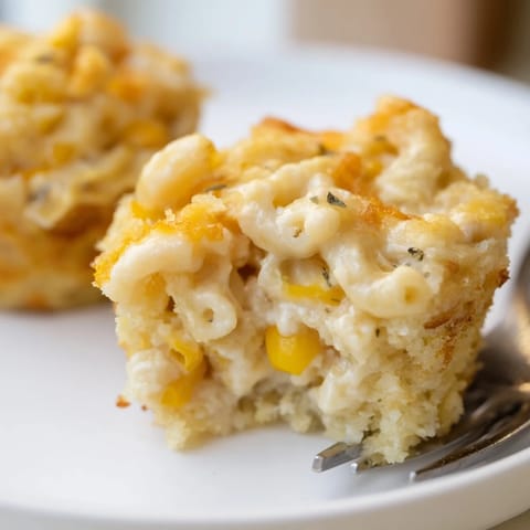 Handheld Mac and Cheese Sweet Corn Muffins topped with melted cheese, perfect for parties.  