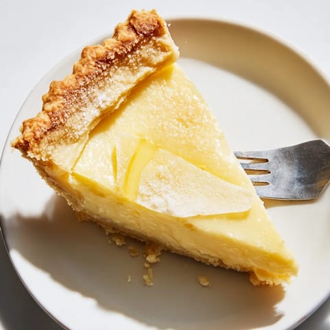 Sliced water pie showcasing its custard-like texture and sweet vanilla aroma.  
