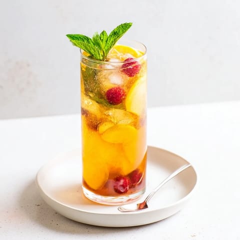 Homemade kombucha-style mocktails brewed with fresh berries and zesty lemon slices.  
