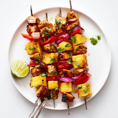 Juicy Sweet & Savory Pineapple Chicken Skewers grilled with colorful veggies and vibrant flavors.  