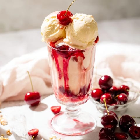 Enjoy the beautiful Homemade Fruit Soda Floats with vanilla ice cream and the sweet, tangy cherry syrup swirling within.