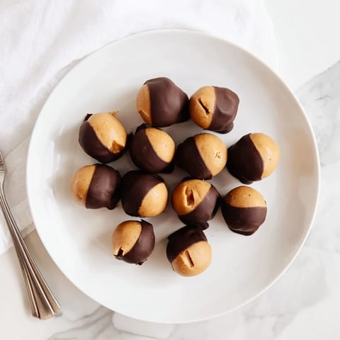 Close-up of freshly made Peanut Butter Buckeyes, showing the creamy peanut butter centers ready to eat.