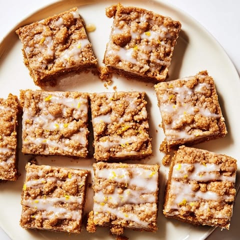 Buttery crumble tops golden baked Lemon-Glazed Gingerbread Crumble Bars, ready for a delicious dessert.