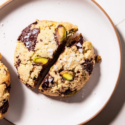 Golden, crisp Salted Pistachio Chocolate Chunk Shortbread, showcasing the texture of pistachios and dark chocolate.