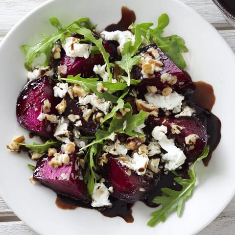 A fresh, colorful Roasted Beet Goat Cheese Salad, drizzled with balsamic vinaigrette, ready to serve.