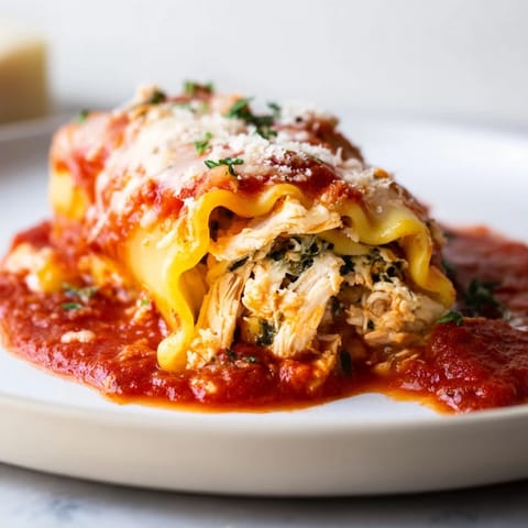 Creamy filling bursting from warm Chicken and Spinach Lasagna Rolls, a comforting homemade Italian dinner.