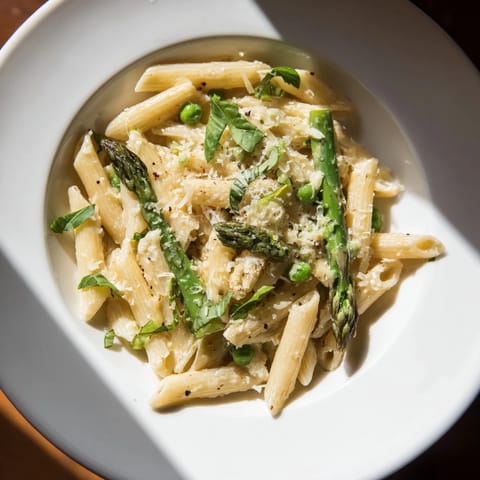 This Garlic Parmesan Spring Vegetable Pasta features tender green beans and asparagus in a rich, flavorful sauce.