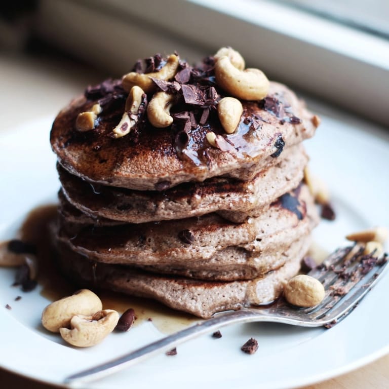 Homemade Protein Chocolate Cashew Pancakes recipe—a stack of fluffy, delicious breakfast goodness.