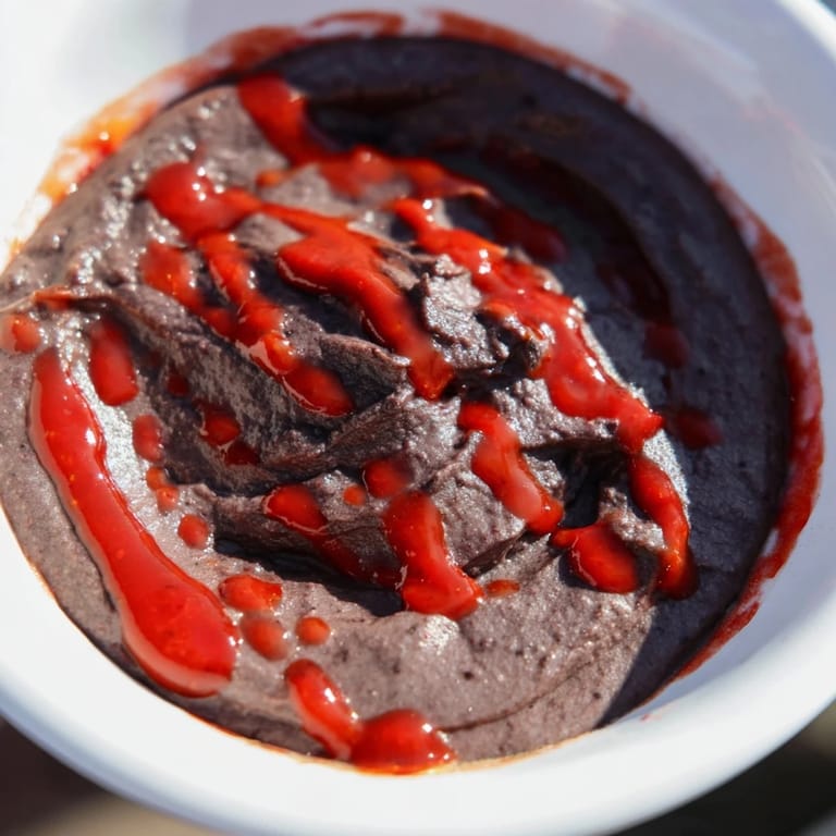 A flavorful, zesty black bean dip, easily made with salsa and hot sauce, ready to serve.