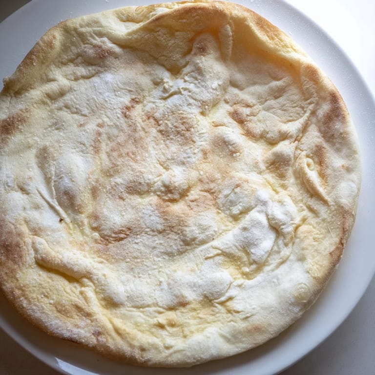 Freshly cooked cottage cheese flatbread, showing lovely bubbles and a slightly charred crust, perfect.