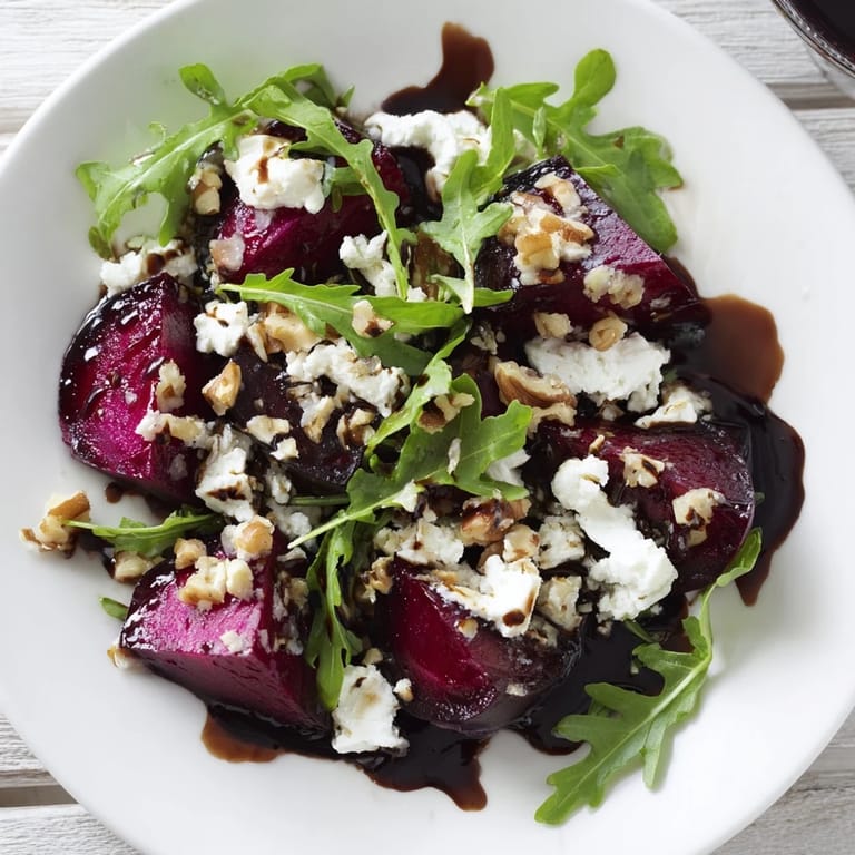 A fresh, colorful Roasted Beet Goat Cheese Salad, drizzled with balsamic vinaigrette, ready to serve.