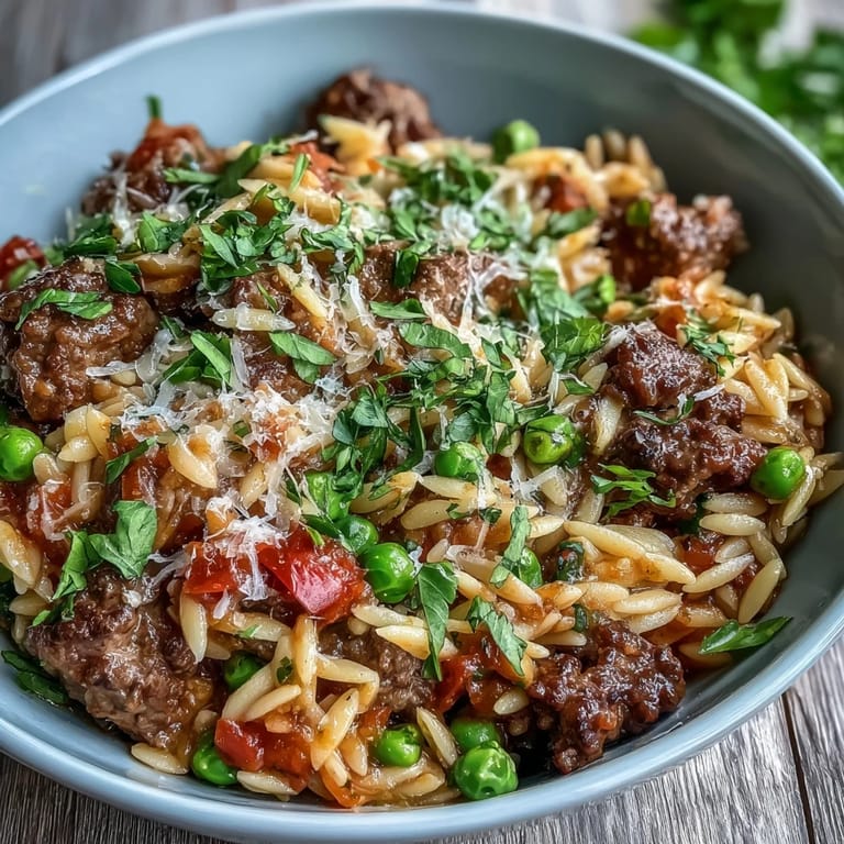 Cozy Comforting Ground Beef Orzo Dinner served in a rustic bowl, featuring tender orzo, sweet peppers, and rich tomato broth.