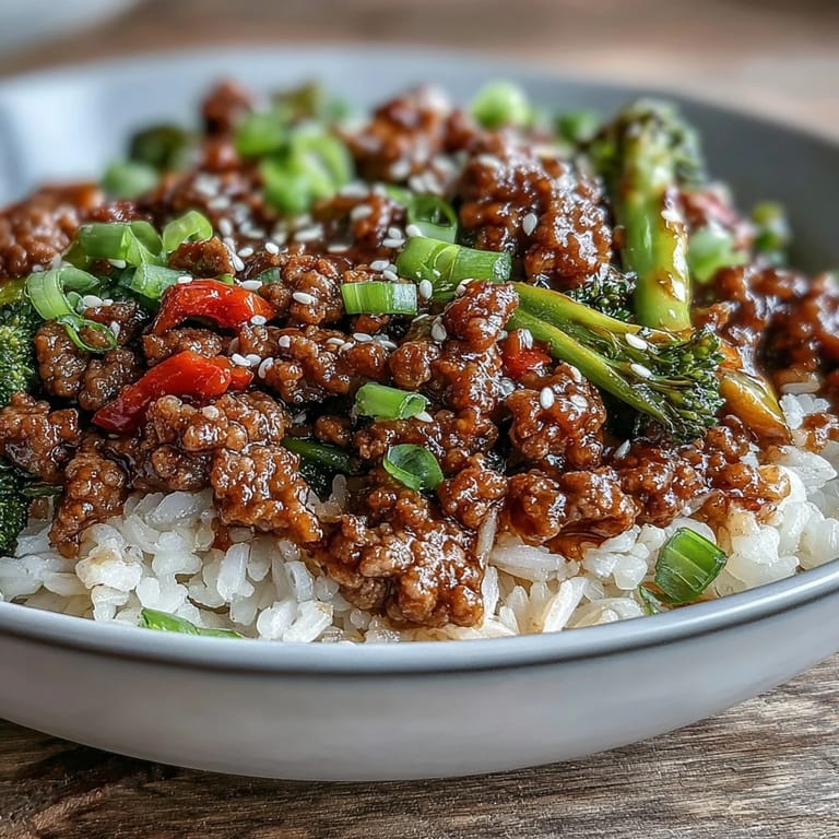 Savory ground beef and fresh vegetables over rice in convenient meal prep bowls for easy lunches.