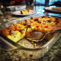 A casserole dish with a spoon in it.