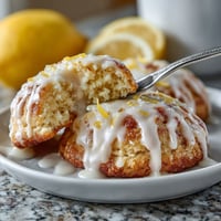 A plate of meltaway cookies with lemon glaze.