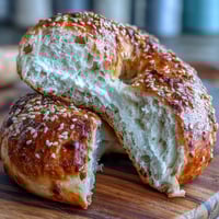 Two-ingredient yogurt bagels made with self-rising flour and Greek yogurt, baked until golden and topped with sesame seeds for a chewy, satisfying breakfast.