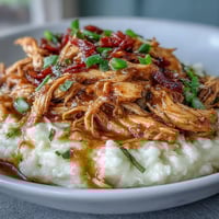 Slow Cooker Mississippi Chicken with Garlic Mashed Potatoes in a creamy, savory sauce served over buttery mashed potatoes.  