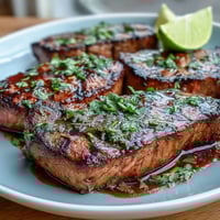 Grilled salmon fillets topped with vibrant strawberry salsa and fresh cilantro. A bright, flavorful dish perfect for spring and summer dining.