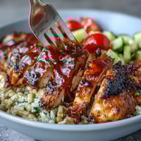 High-protein BBQ chicken bowl with smoky grilled chicken, brown rice, and crisp veggies.  