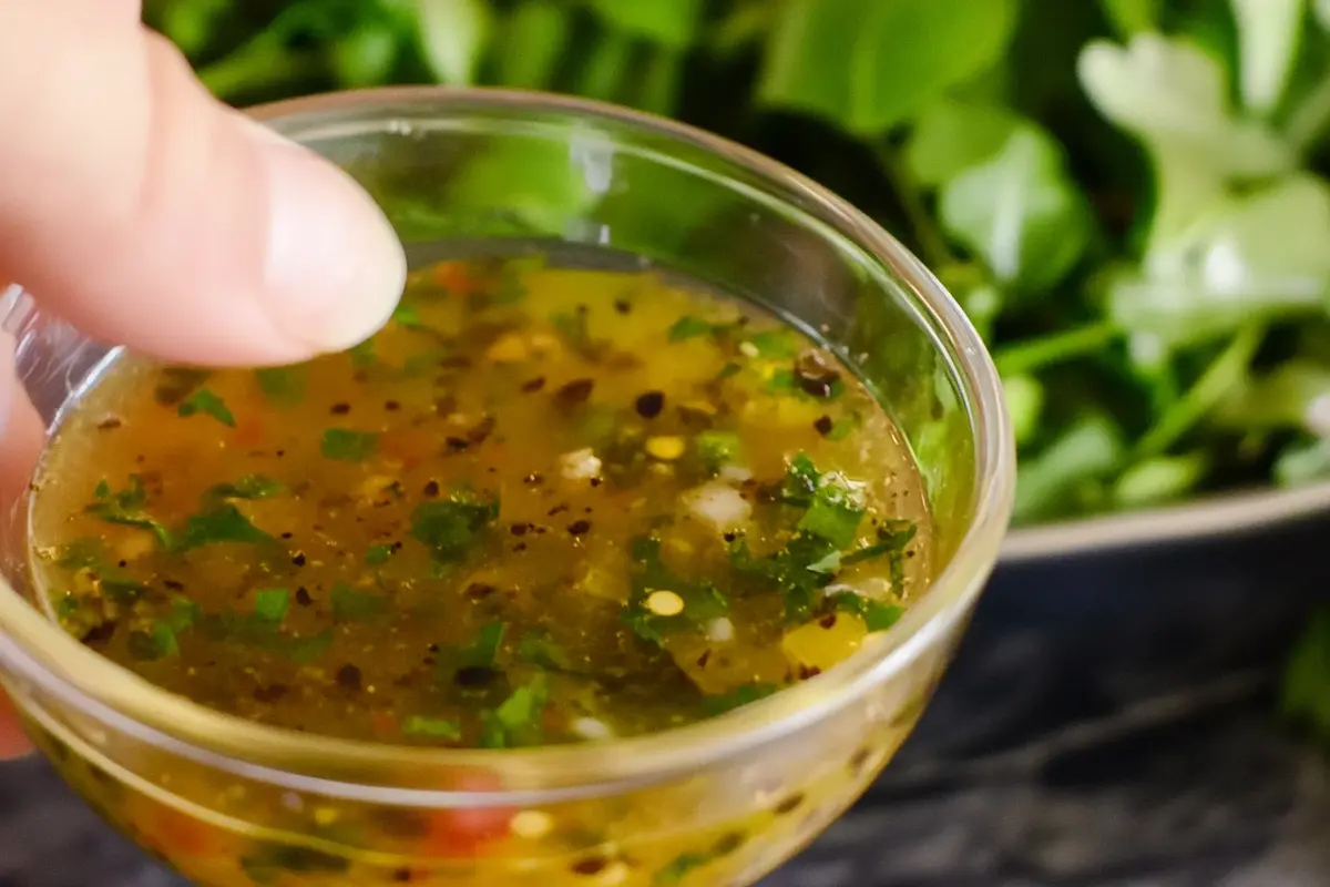 Freshly made Spanish salad dressing on a salad.