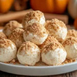 Creamy no bake pumpkin cheesecake balls rolled in crushed gingersnap cookies.